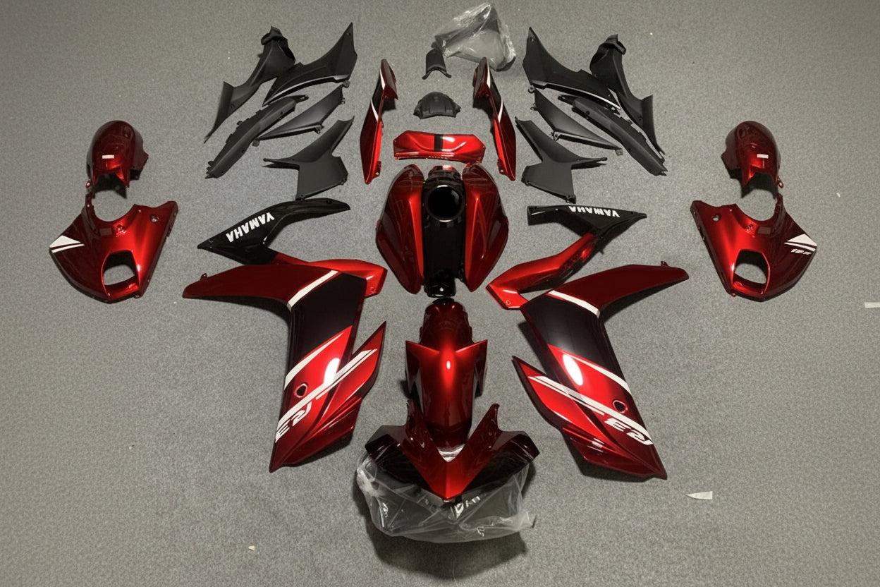 Red and black motorcycle body parts on a gray background