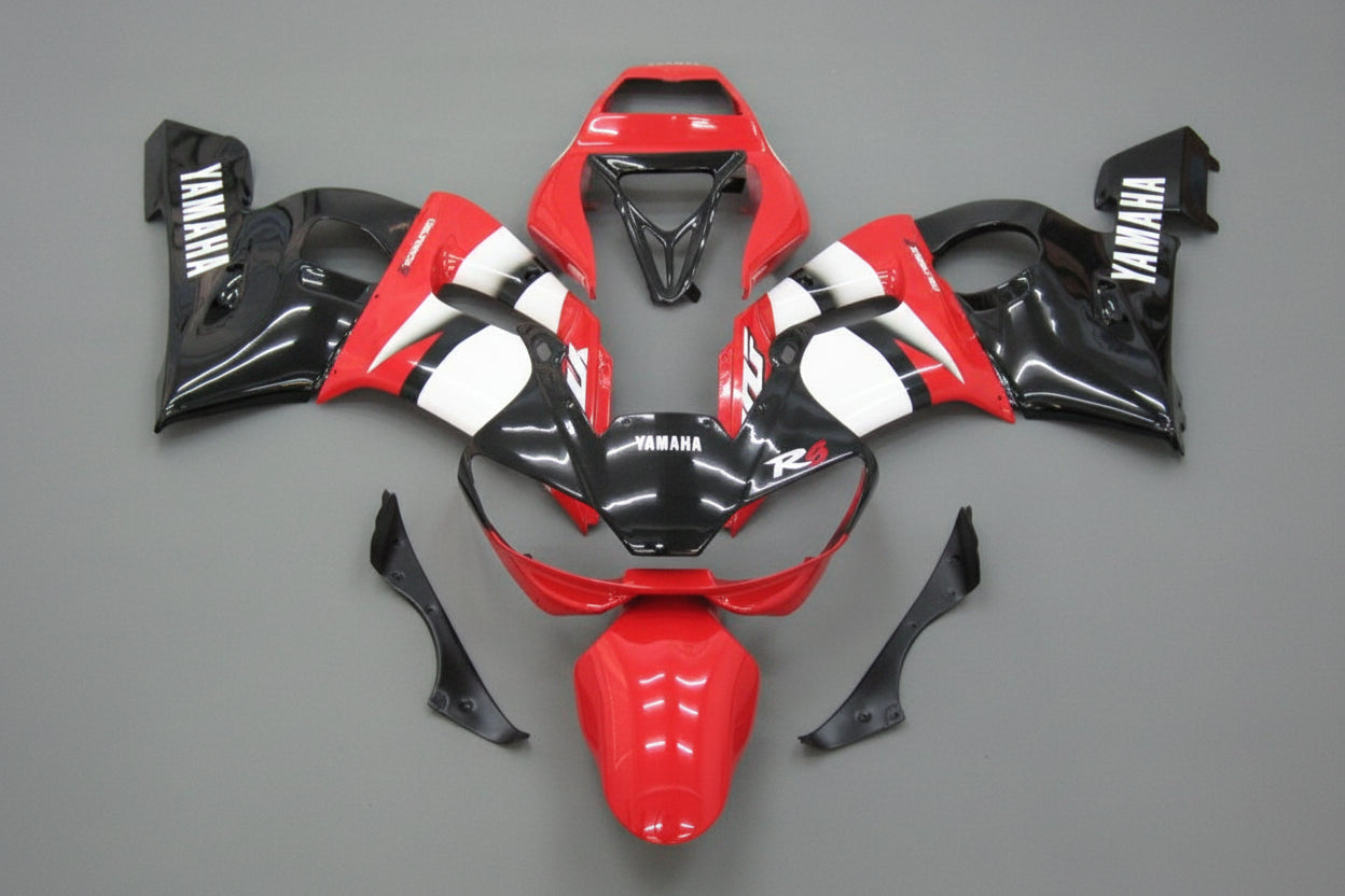 Red, black, and white motorcycle bodywork on a gray background