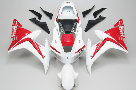 Motorcycle bodywork pieces with red and white design on a white background