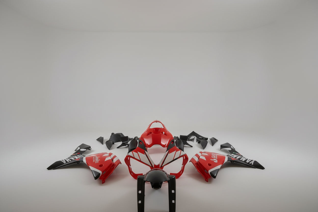 Motorcycle body parts with red and black design on a white background