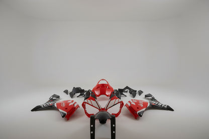 Motorcycle body parts with red and black design on a white background