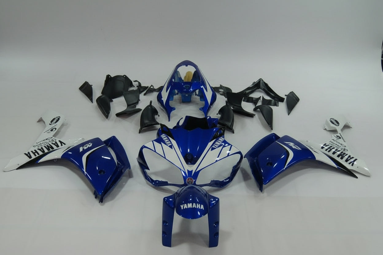 Blue and white Yamaha motorcycle parts on a gray background