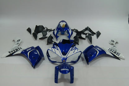 Blue and white Yamaha motorcycle parts on a gray background