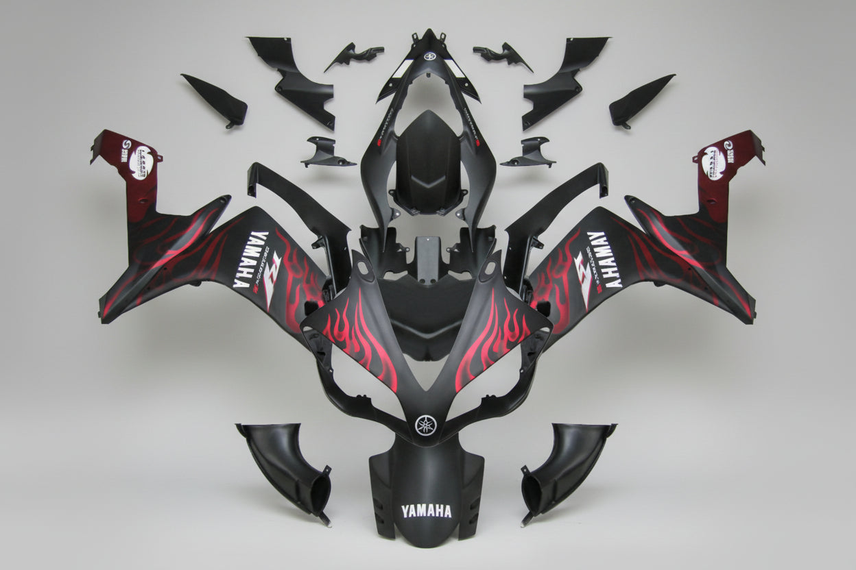 Motorcycle bodywork with red and black design on a white background