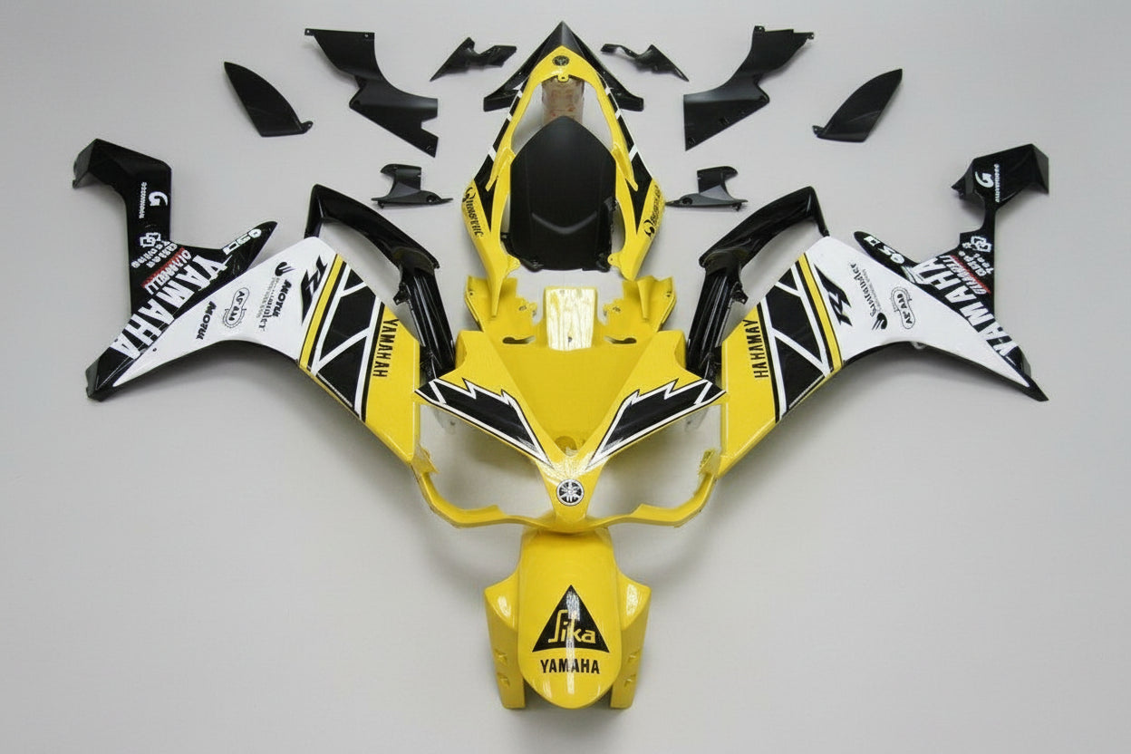 Yellow and black motorcycle body kit with branding on a white background