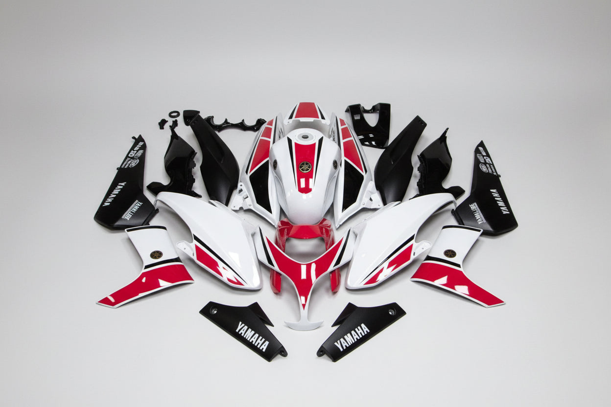 Motorcycle body panels with red and black design on a white background