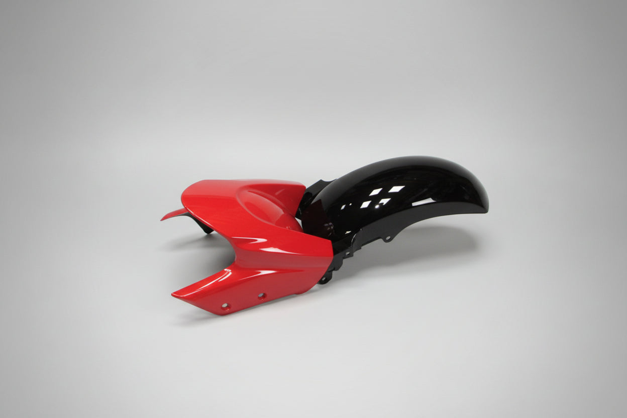 Red and black motorcycle fender on a white background