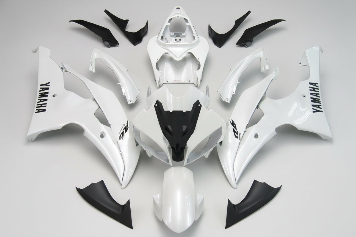 White and black motorcycle body parts with Yamaha branding on a white background