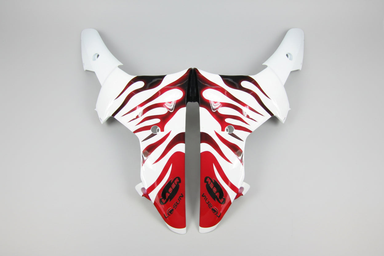 Motorcycle fairing with red and black flame design on a white background