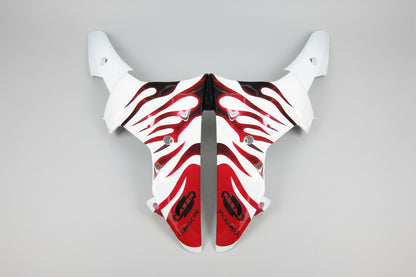 Motorcycle fairing with red and black flame design on a white background