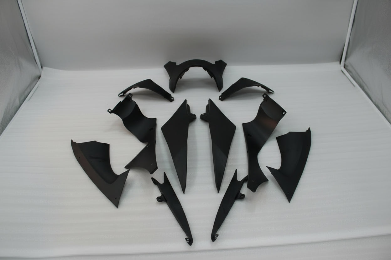 Set of black motorcycle body panels on a white background