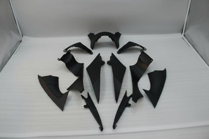Set of black motorcycle body panels on a white background