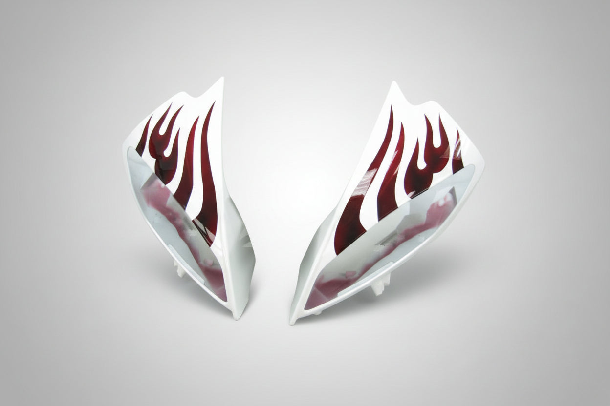 Car side skirts with red flame design on a white background
