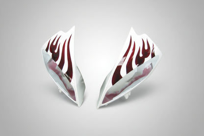Car side skirts with red flame design on a white background
