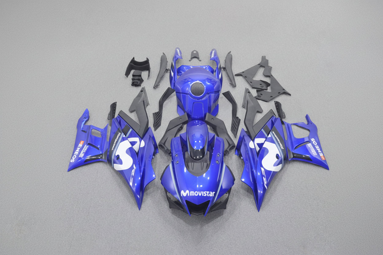 Blue motorcycle body parts on a gray background