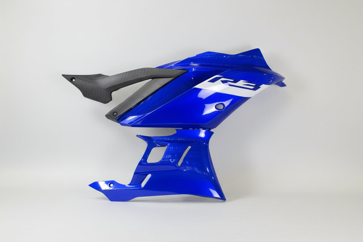 Blue motorcycle fender with carbon fiber texture on a white background