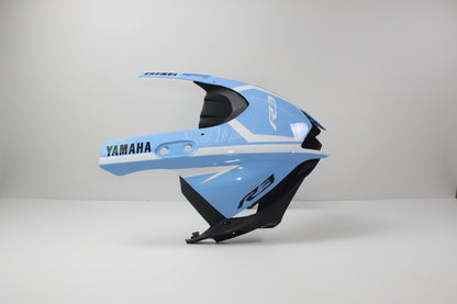 Blue motorcycle fairing with Yamaha branding on a white background