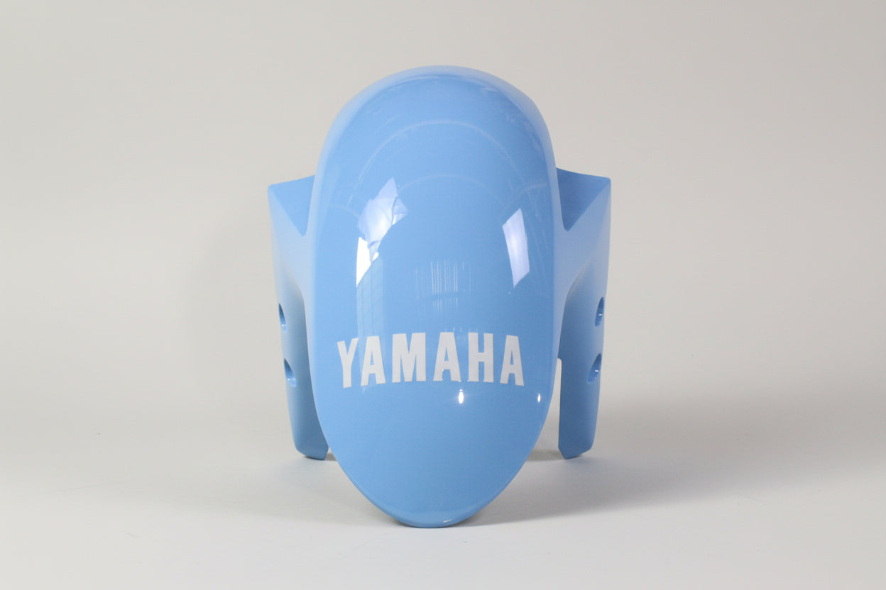 Blue motorcycle fender with 'Yamaha' branding on a white background