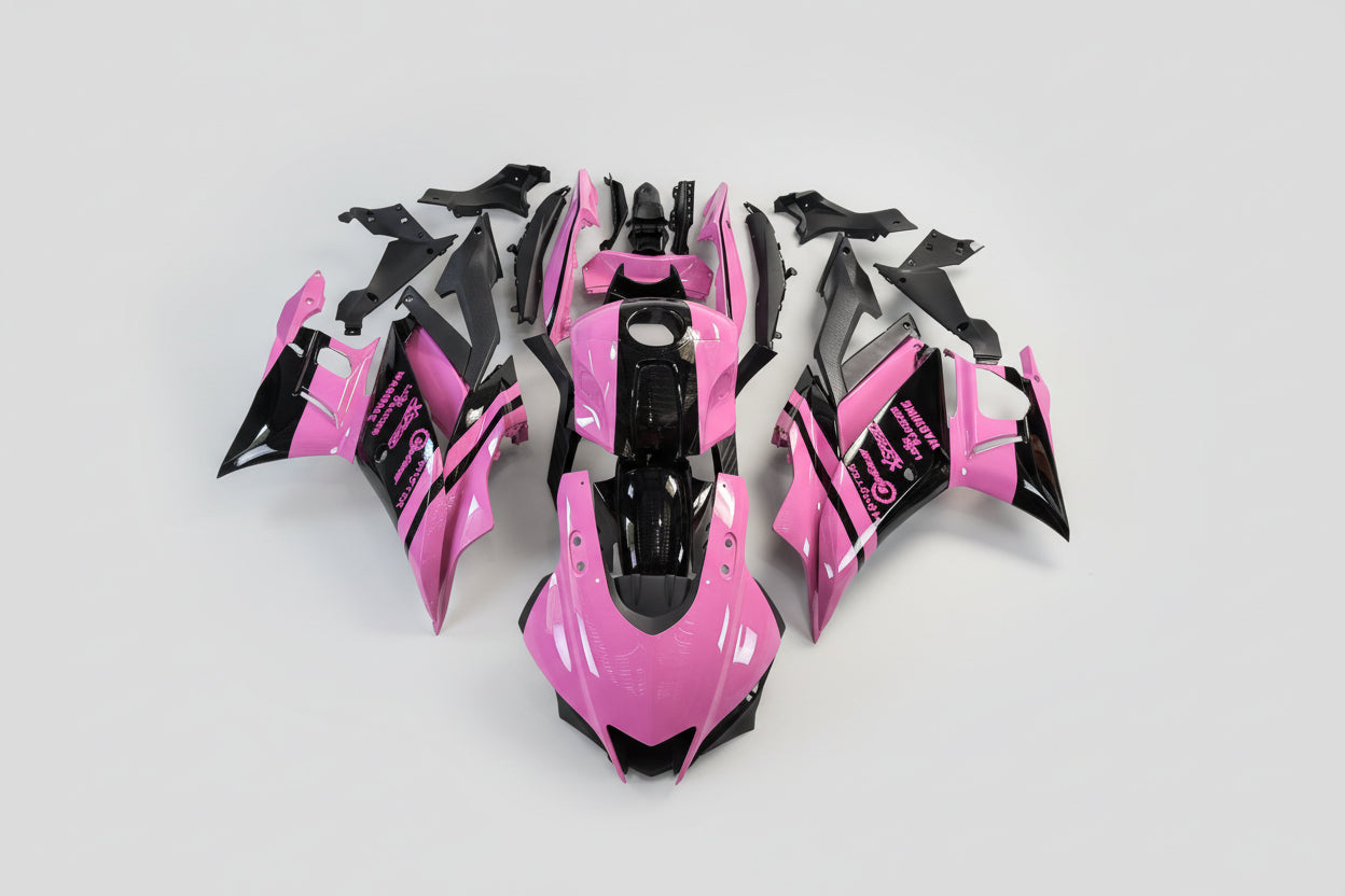 Pink and black motorcycle body parts on a white background
