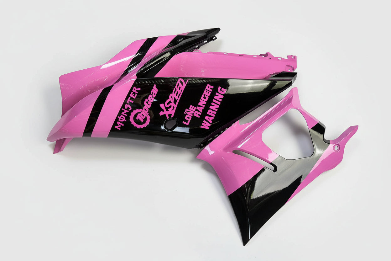 Pink and black motorcycle bodywork with text on a white background