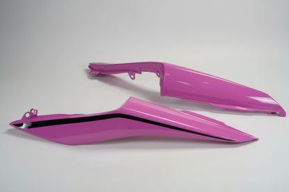 Two pink plastic parts on a white background