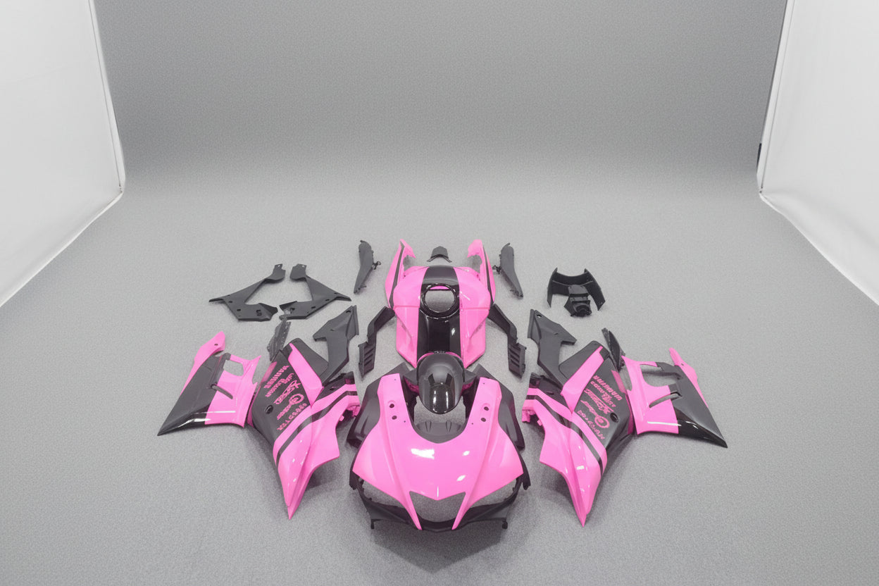 Pink and black motorcycle body parts on a gray background