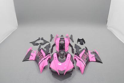 Pink and black motorcycle body parts on a gray background