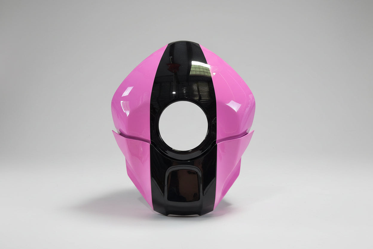 Pink and black motorcycle helmet on a white background