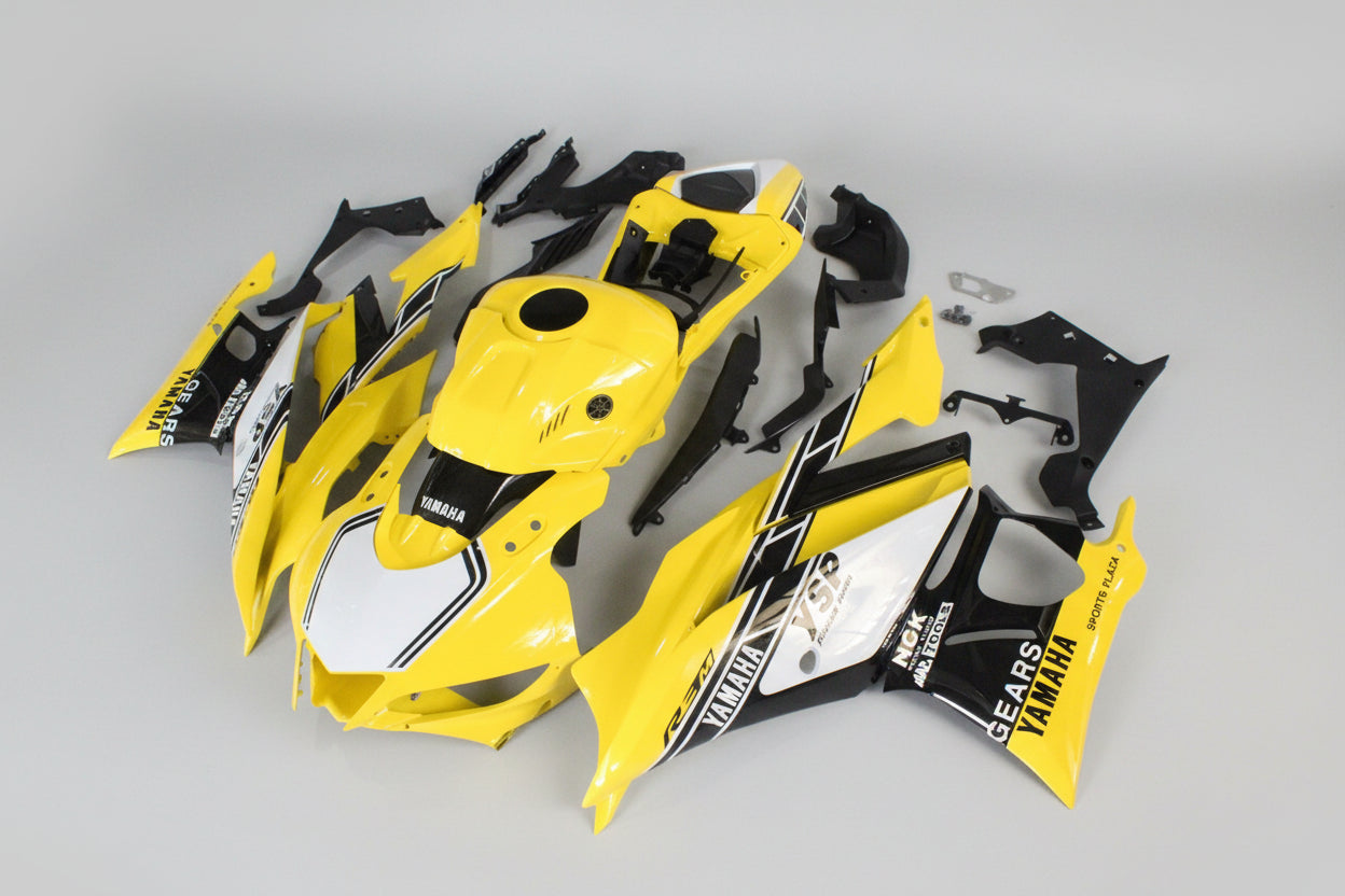 Yellow and black motorcycle body parts on a white background