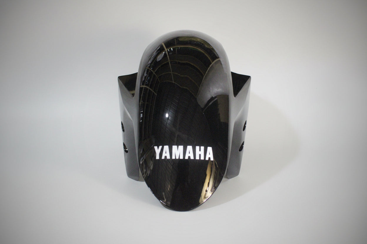 Black motorcycle fairing with 'Yamaha' branding on a white background