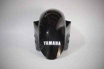 Black motorcycle fairing with 'Yamaha' branding on a white background