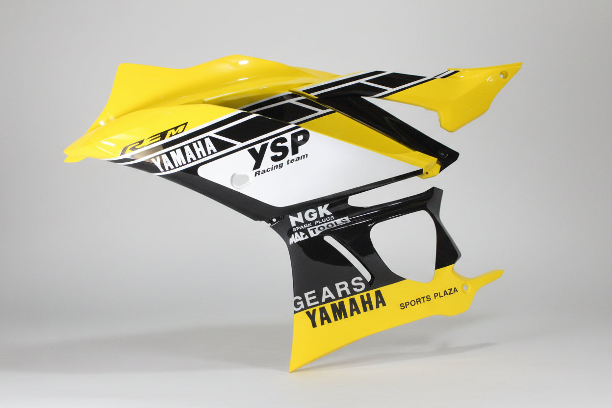 Yellow and black motorcycle fender with branding on a white background