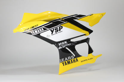 Yellow and black motorcycle fender with branding on a white background