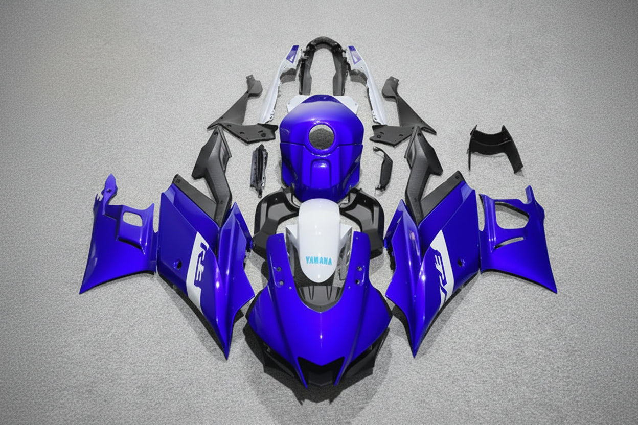Blue motorcycle bodywork pieces on a gray background