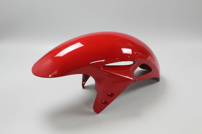 Glossy red motorcycle fender on a white background