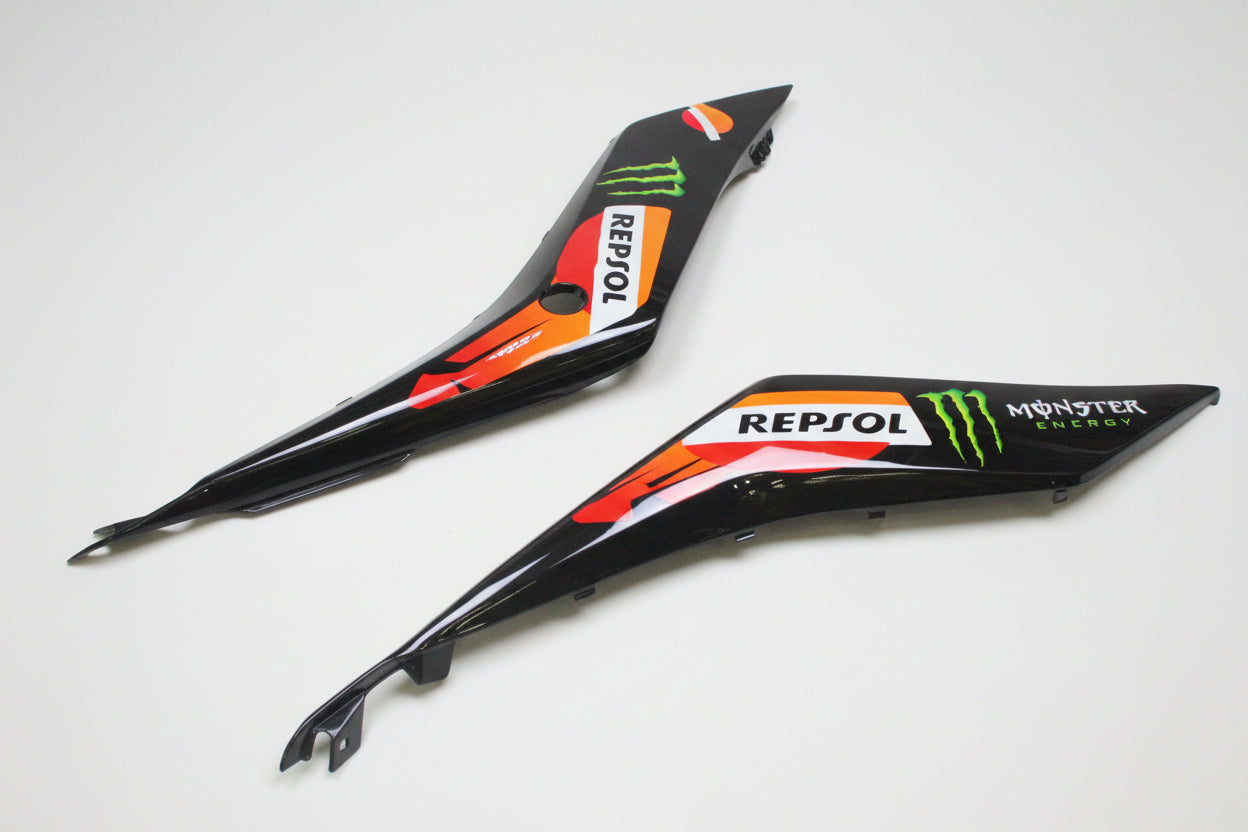 Black motorcycle fairing panels with branding on a white background