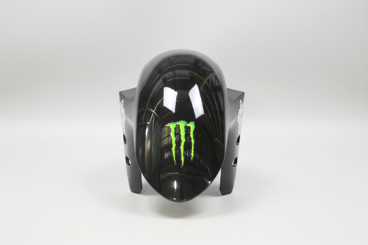Black motorcycle fairing with green logo on a white background