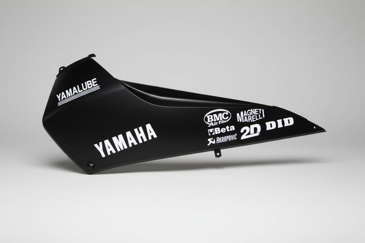 Black motorcycle fender with various brand logos on a white background