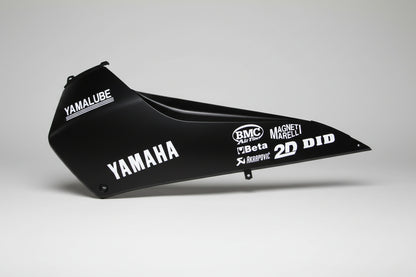 Black motorcycle fender with various brand logos on a white background